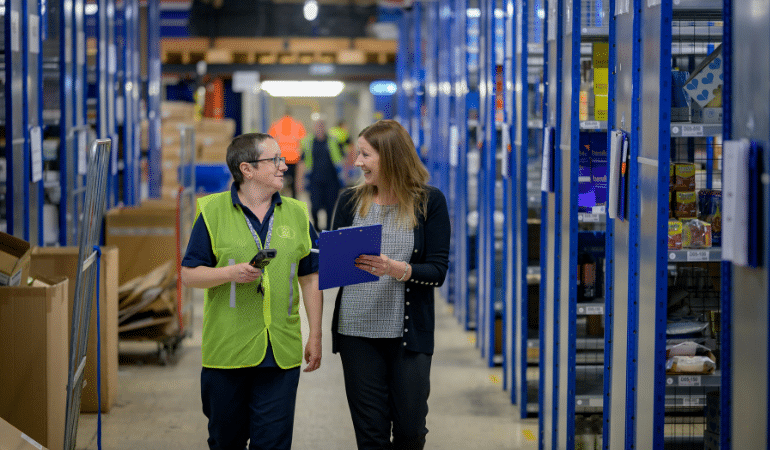 People in warehouse smiling